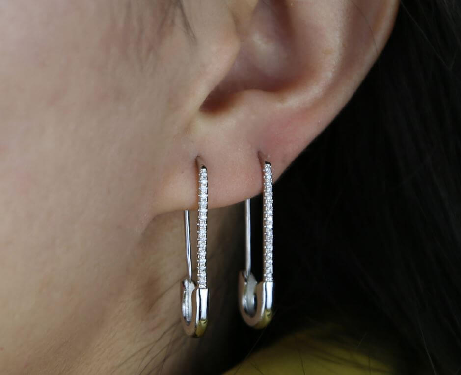 what does it mean to wear safety pins as earrings