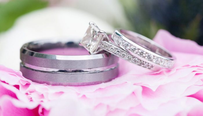 Wedding rings over a pink flower